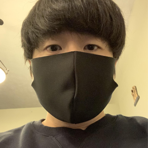 Photo of Hongsoon in a black face mask looking at the camera